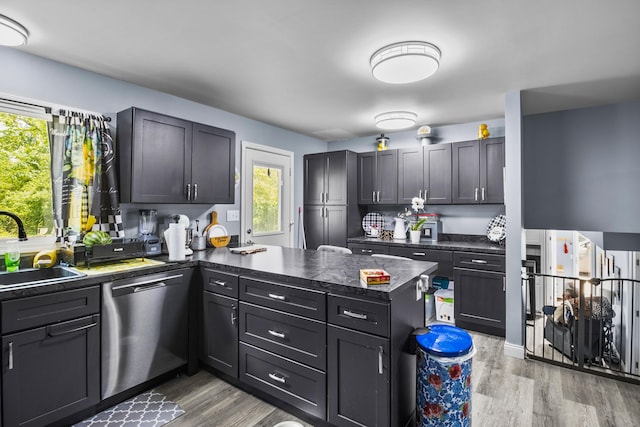 168 Perry Ln, London, KY 40741 - kitchen with dishwasher, a peninsula, dark countertops, and light wood-style flooring