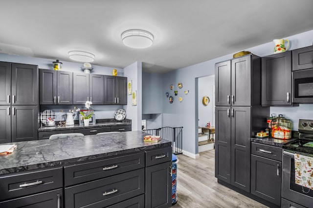 168 Perry Ln, London, KY 40741 - kitchen with stainless steel appliances, light wood-type flooring, and dark stone countertops