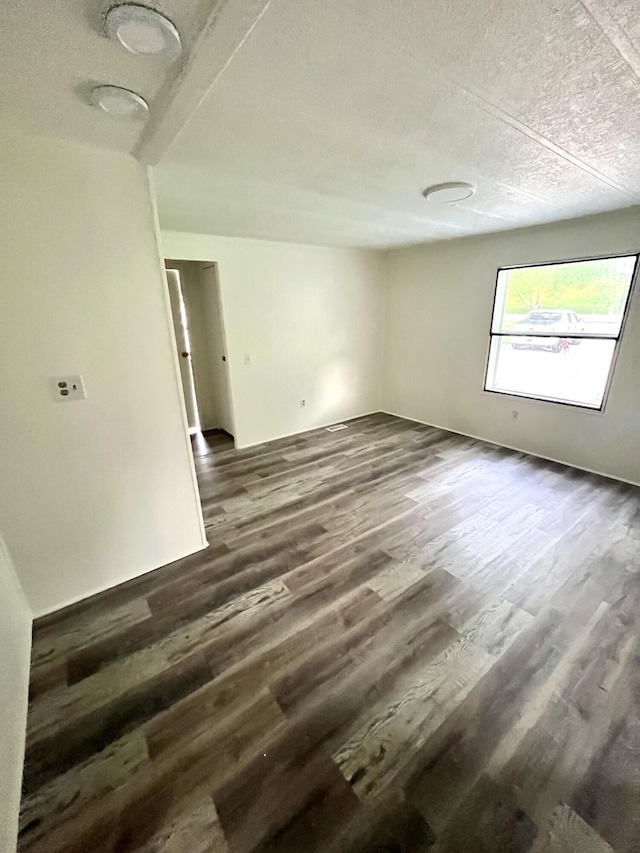 6006 US-60, Morehead, KY 40351 - empty room with dark wood-type flooring and a textured ceiling