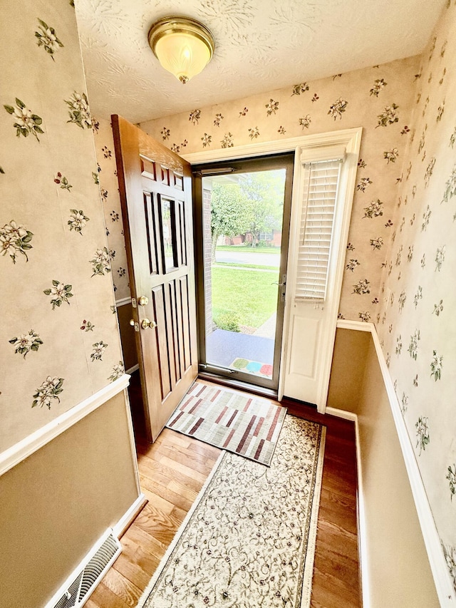 1012 Heathcliff Dr, Richmond, KY 40475 - doorway to outside featuring light wood-type flooring and wallpapered walls
