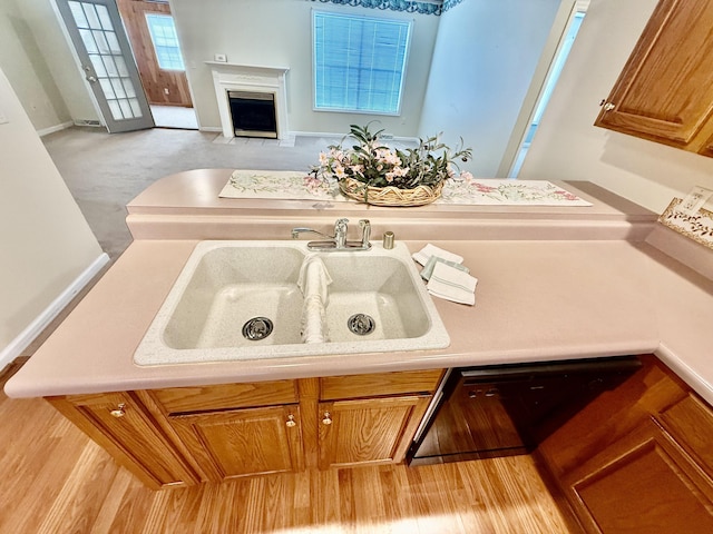 1012 Heathcliff Dr, Richmond, KY 40475 - kitchen featuring a fireplace with flush hearth, brown cabinets, and light countertops