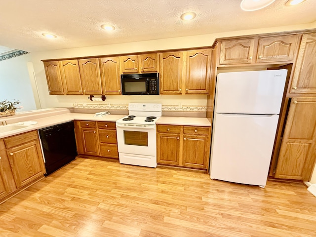 1012 Heathcliff Dr, Richmond, KY 40475 - kitchen with black appliances, light wood-type flooring, brown cabinetry, a textured ceiling, and recessed lighting