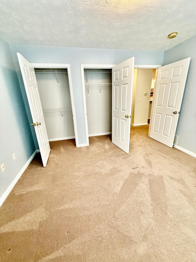 1012 Heathcliff Dr, Richmond, KY 40475 - unfurnished bedroom featuring two closets, carpet, and a textured ceiling