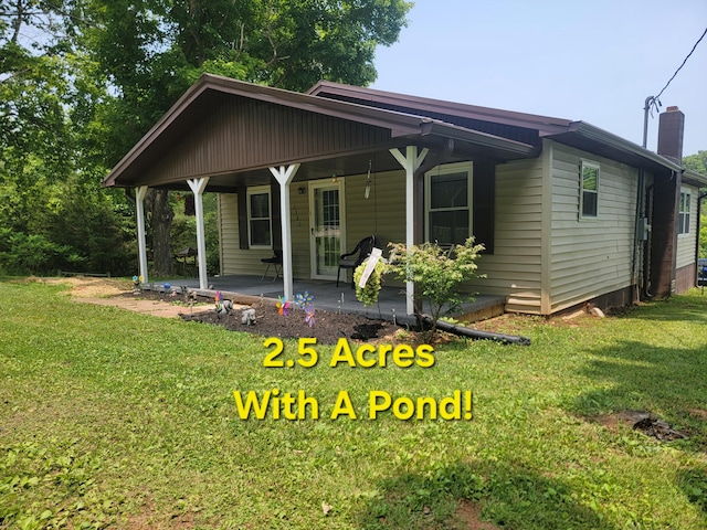 3380 Upton Talley Rd, Upton, KY 42784 - view of front facade with a porch, a front yard, and a chimney