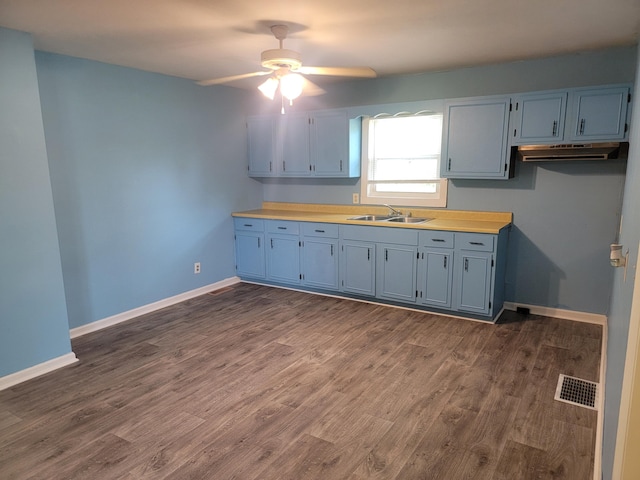 3380 Upton Talley Rd, Upton, KY 42784 - kitchen featuring a ceiling fan, dark wood-style floors, blue cabinetry, under cabinet range hood, and light countertops