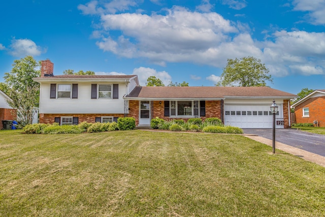 120 Vanderbilt Dr, Lexington, KY 40517 - tri-level home featuring asphalt driveway, an attached garage, a chimney, and brick siding