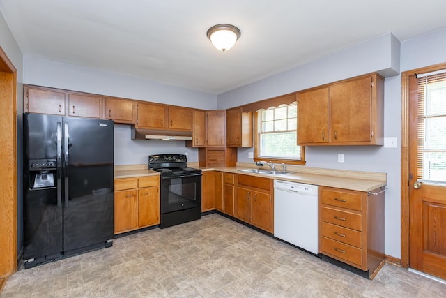 120 Vanderbilt Dr, Lexington, KY 40517 - kitchen featuring black appliances, light countertops, brown cabinetry, and under cabinet range hood