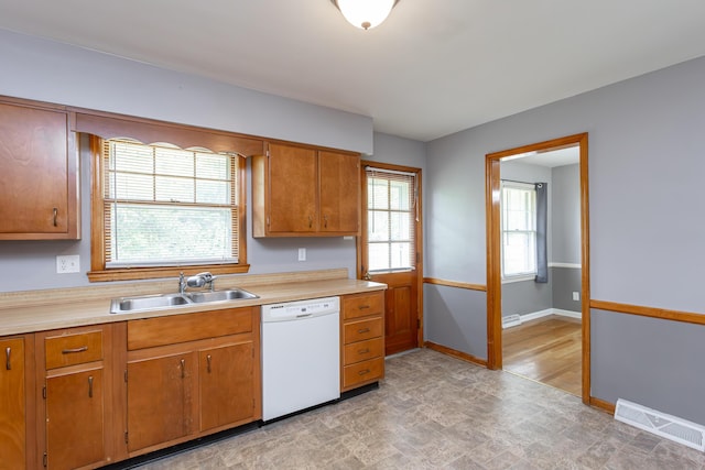 120 Vanderbilt Dr, Lexington, KY 40517 - kitchen featuring dishwasher, light countertops, brown cabinets, and plenty of natural light