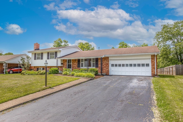 120 Vanderbilt Dr, Lexington, KY 40517 - split level home featuring brick siding, driveway, an attached garage, and a chimney