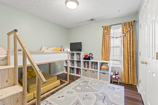 821 White Wood Flt, Lexington, KY 40511 - bedroom with wood finished floors, a textured ceiling, and a closet