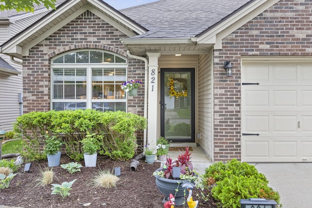 821 White Wood Flt, Lexington, KY 40511 - property entrance featuring brick siding, an attached garage, and a shingled roof