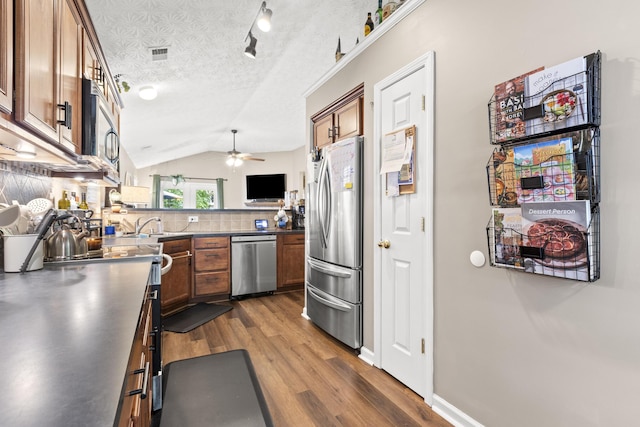 821 White Wood Flt, Lexington, KY 40511 - kitchen with appliances with stainless steel finishes, ceiling fan, dark wood-style floors, brown cabinets, and lofted ceiling