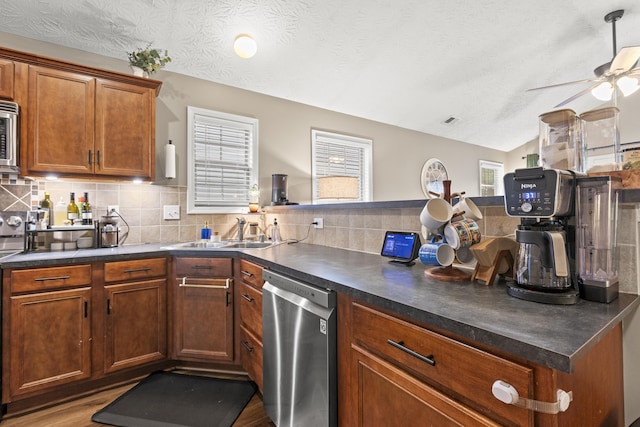 821 White Wood Flt, Lexington, KY 40511 - kitchen featuring stainless steel appliances, decorative backsplash, ceiling fan, lofted ceiling, and brown cabinets