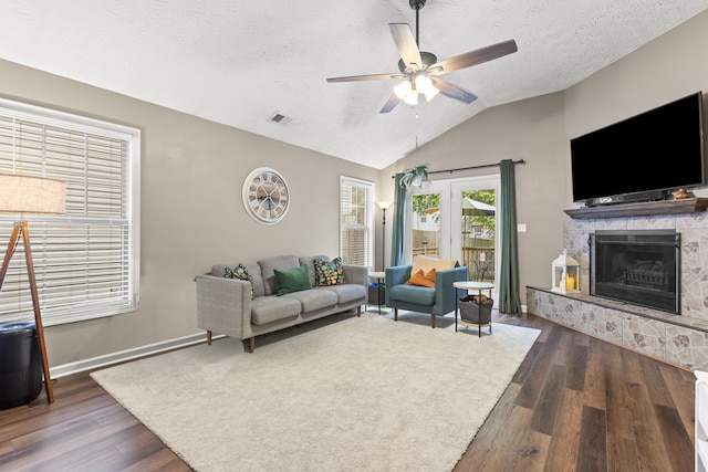 821 White Wood Flt, Lexington, KY 40511 - living room featuring dark wood-style flooring, lofted ceiling, ceiling fan, a fireplace, and a textured ceiling
