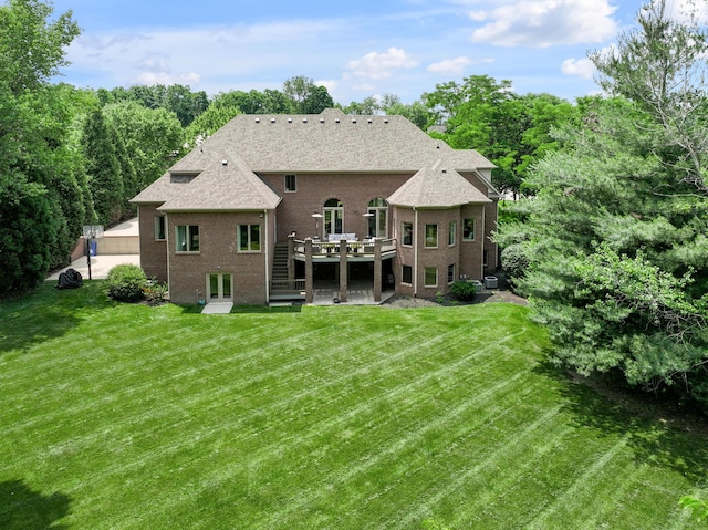 103 Windridge Dr, Nicholasville, KY 40356 - rear view of property with a wooden deck, brick siding, a lawn, and a shingled roof