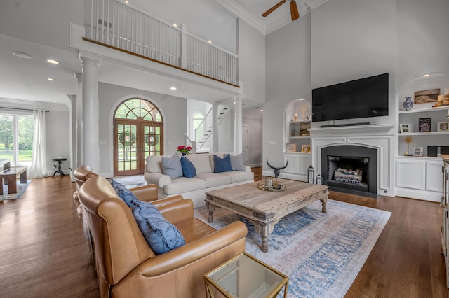 103 Windridge Dr, Nicholasville, KY 40356 - living room with a towering ceiling, a fireplace, wood finished floors, decorative columns, and crown molding