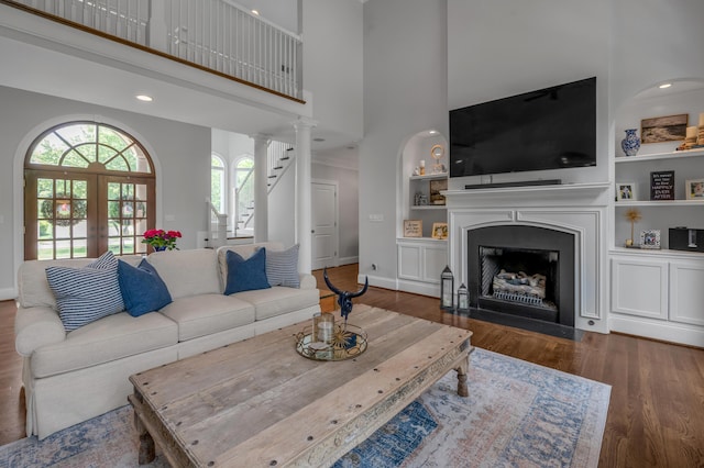 103 Windridge Dr, Nicholasville, KY 40356 - living room with a high ceiling, healthy amount of natural light, wood finished floors, a fireplace with flush hearth, and built in shelves