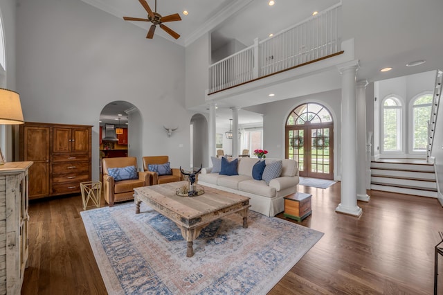 103 Windridge Dr, Nicholasville, KY 40356 - living area with decorative columns, arched walkways, a ceiling fan, a high ceiling, and dark wood finished floors