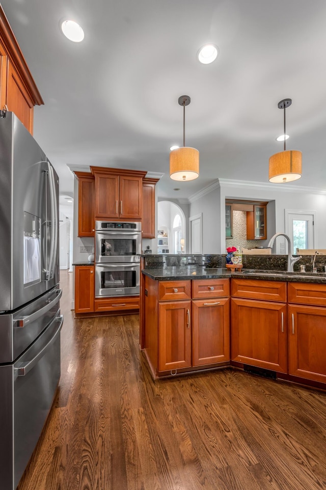 103 Windridge Dr, Nicholasville, KY 40356 - kitchen with stainless steel appliances, ornamental molding, dark wood-style flooring, decorative light fixtures, and dark stone countertops