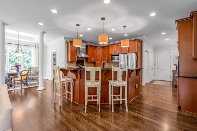 103 Windridge Dr, Nicholasville, KY 40356 - kitchen with stainless steel appliances, crown molding, ornate columns, recessed lighting, and wall chimney exhaust hood
