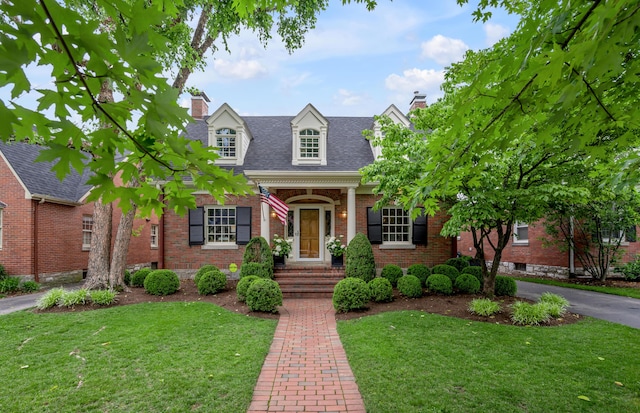 341 Kingsway Dr, Lexington, KY 40502 - new england style home featuring a chimney, brick siding, a front yard, and roof with shingles