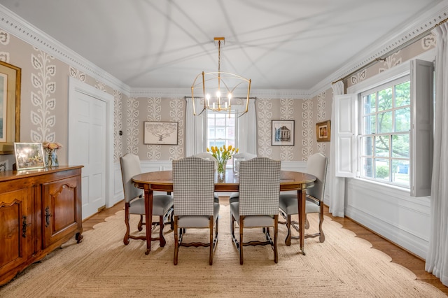 341 Kingsway Dr, Lexington, KY 40502 - dining space with wallpapered walls, a chandelier, light wood-style flooring, crown molding, and a wainscoted wall
