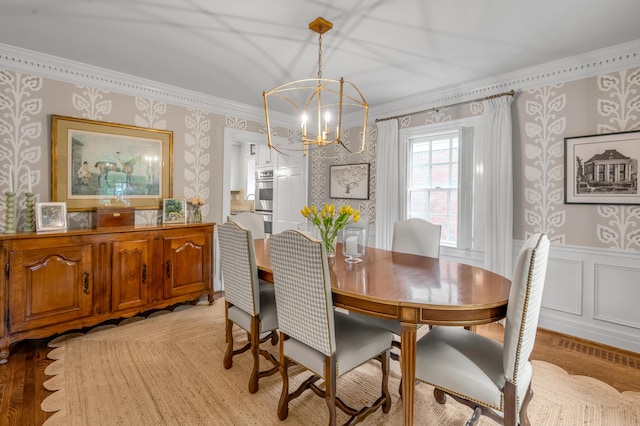 341 Kingsway Dr, Lexington, KY 40502 - dining area with wallpapered walls, crown molding, a chandelier, wainscoting, and a decorative wall