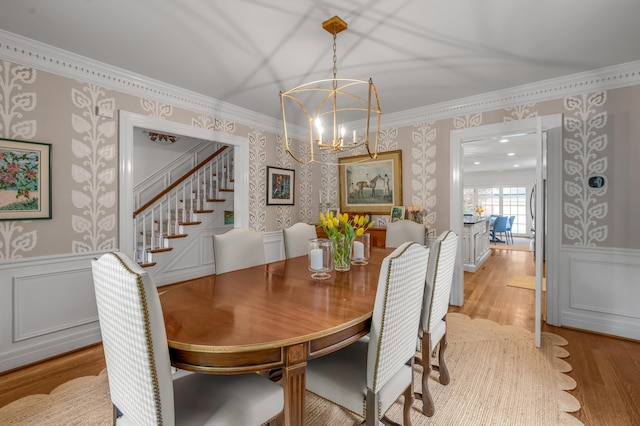 341 Kingsway Dr, Lexington, KY 40502 - dining area featuring wallpapered walls, stairway, a chandelier, wainscoting, and crown molding