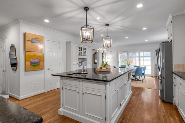 341 Kingsway Dr, Lexington, KY 40502 - kitchen featuring freestanding refrigerator, white cabinetry, a chandelier, a kitchen island, and dark stone counters