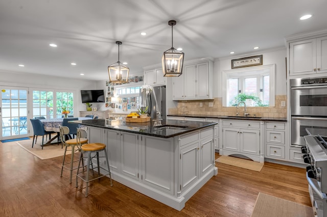 341 Kingsway Dr, Lexington, KY 40502 - kitchen featuring appliances with stainless steel finishes, tasteful backsplash, a center island with sink, healthy amount of natural light, and recessed lighting