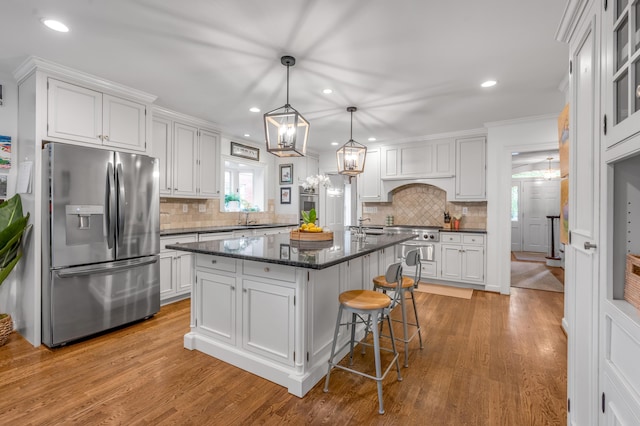 341 Kingsway Dr, Lexington, KY 40502 - kitchen featuring appliances with stainless steel finishes, a center island, white cabinetry, a chandelier, and recessed lighting