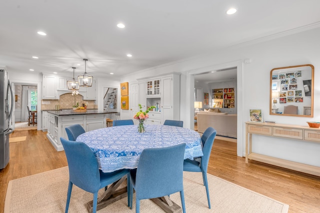 341 Kingsway Dr, Lexington, KY 40502 - dining room featuring stairway, recessed lighting, ornamental molding, light wood-style flooring, and a chandelier