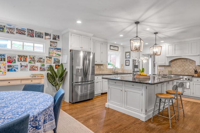 341 Kingsway Dr, Lexington, KY 40502 - kitchen featuring stainless steel appliances, a chandelier, backsplash, a center island, and white cabinets
