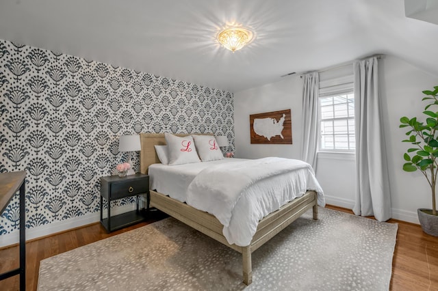 341 Kingsway Dr, Lexington, KY 40502 - bedroom with wallpapered walls, wood finished floors, and an accent wall