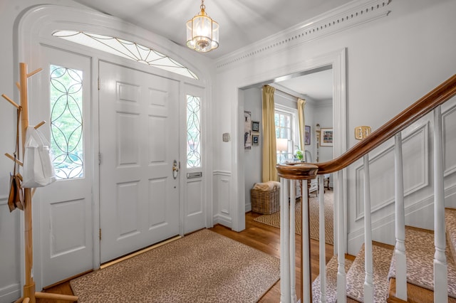 341 Kingsway Dr, Lexington, KY 40502 - foyer featuring plenty of natural light, light wood-style floors, stairs, crown molding, and a chandelier