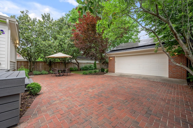 341 Kingsway Dr, Lexington, KY 40502 - garage featuring roof mounted solar panels and decorative driveway