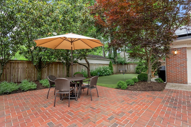 341 Kingsway Dr, Lexington, KY 40502 - fenced backyard featuring an area to practice putting, a patio area, and outdoor dining area