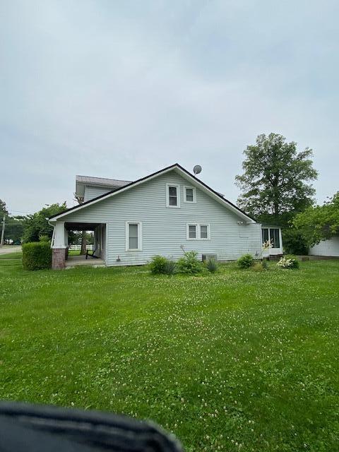 311 N Broadway St, Berea, KY 40403 - view of side of home with a lawn