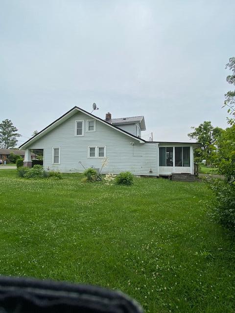 311 N Broadway St, Berea, KY 40403 - view of side of property featuring a sunroom, a chimney, and a yard