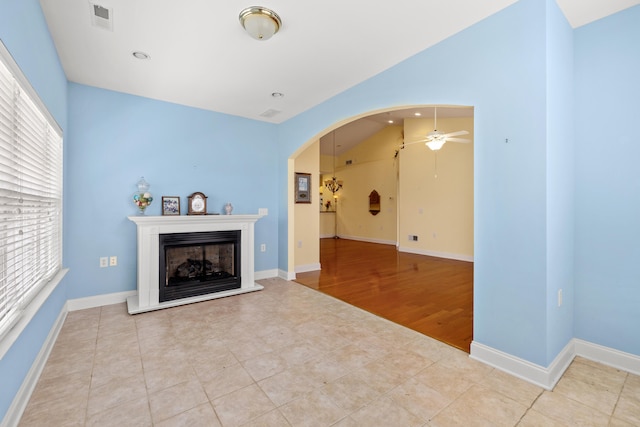 139 Delissa Dr, Georgetown, KY 40324 - tiled living area with ceiling fan, a fireplace with raised hearth, arched walkways, recessed lighting, and lofted ceiling
