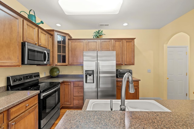 139 Delissa Dr, Georgetown, KY 40324 - kitchen with appliances with stainless steel finishes, brown cabinets, glass insert cabinets, recessed lighting, and light wood-style floors