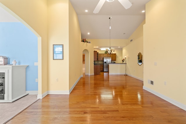 139 Delissa Dr, Georgetown, KY 40324 - unfurnished living room with light wood finished floors, ceiling fan, high vaulted ceiling, arched walkways, and recessed lighting