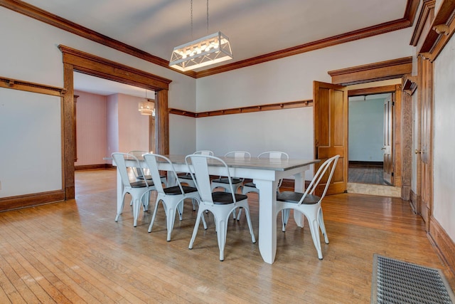 236 W High St, Mt Sterling, KY 40353 - dining room with a chandelier, light wood-style flooring, and crown molding