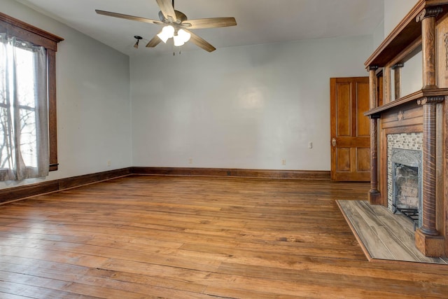 236 W High St, Mt Sterling, KY 40353 - unfurnished living room featuring hardwood / wood-style floors, a tiled fireplace, and a ceiling fan