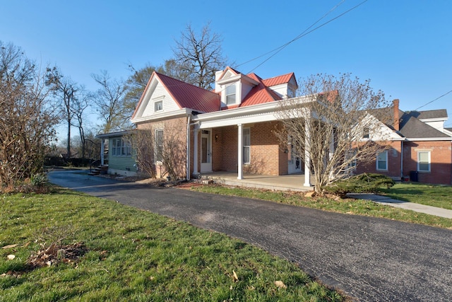 236 W High St, Mt Sterling, KY 40353 - view of front of property featuring brick siding, covered porch, a metal roof, and a front lawn