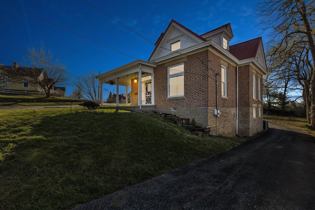 236 W High St, Mt Sterling, KY 40353 - view of front of house featuring a front yard, brick siding, a metal roof, and a porch