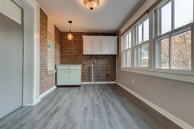 236 W High St, Mt Sterling, KY 40353 - unfurnished living room featuring brick wall and light wood finished floors