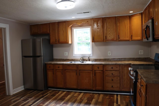 2721 E Ringgold, Somerset, KY 42503 - kitchen with stainless steel appliances, brown cabinets, a textured ceiling, dark wood-style floors, and dark countertops