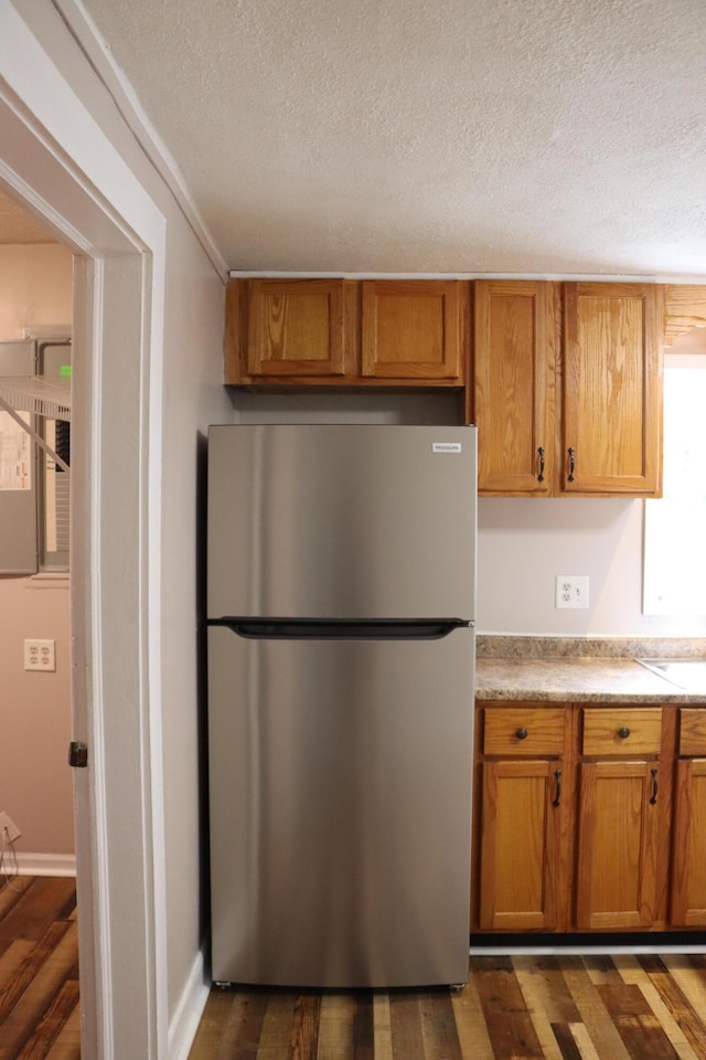 2721 E Ringgold, Somerset, KY 42503 - kitchen featuring freestanding refrigerator, a textured ceiling, dark wood-style flooring, brown cabinets, and light countertops
