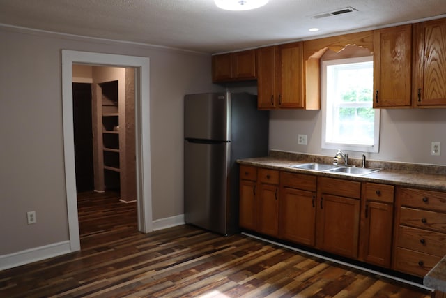 2721 E Ringgold, Somerset, KY 42503 - kitchen with freestanding refrigerator, dark wood-style floors, brown cabinets, dark countertops, and crown molding